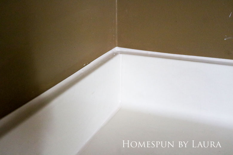 Replacing old caulk makes a dramatic impact in a bathroom. | Homespun by Laura