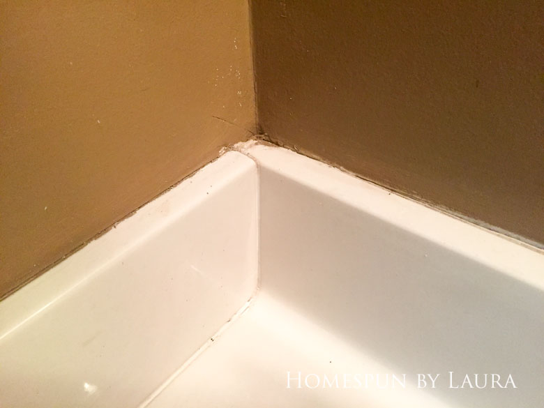 Replacing old caulk makes a dramatic impact in a bathroom. | Homespun by Laura