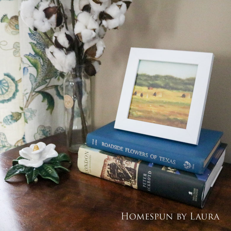 Cleaned up antique brass hardware, cotton stems, and hardback books dress up a boring desk in the den | Homespun by Laura