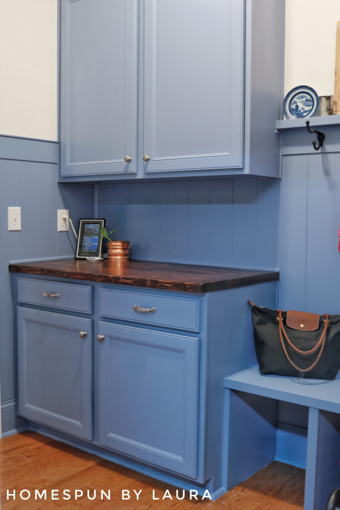 DIY Mud Room with vertical shiplap planks, hooks, and storage bench Reveal