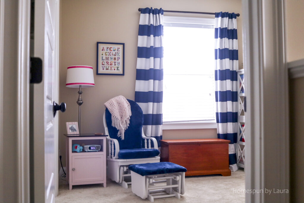 vintage toy nursery reveal - using mom and dad's childhood toys to decorate a nursery; pops of pink make it a pretty, cozy, and feminine space.