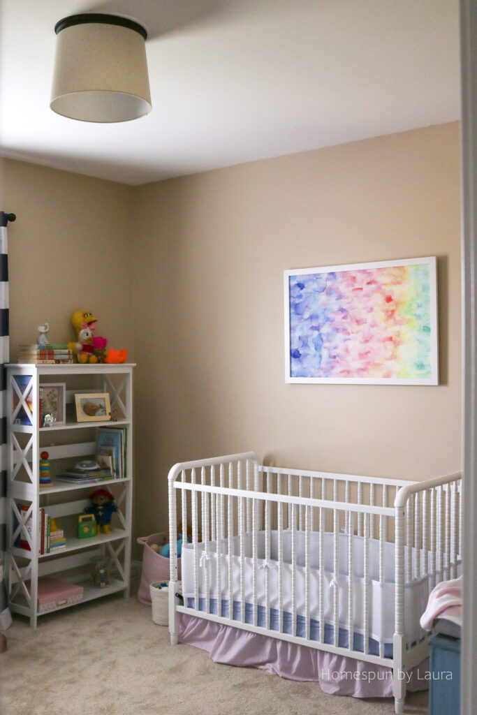 vintage toy nursery reveal - using mom and dad's childhood toys to decorate a nursery; pops of pink make it a pretty, cozy, and feminine space.