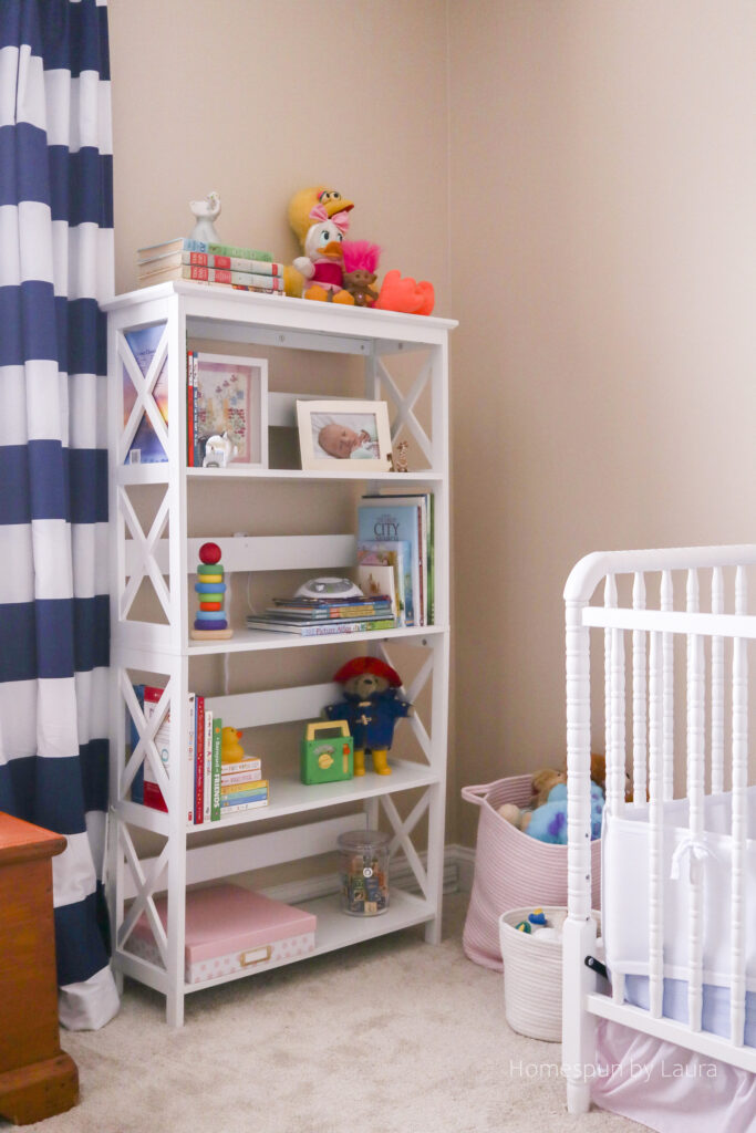 vintage toy nursery reveal - using mom and dad's childhood toys to decorate a nursery; pops of pink make it a pretty, cozy, and feminine space.