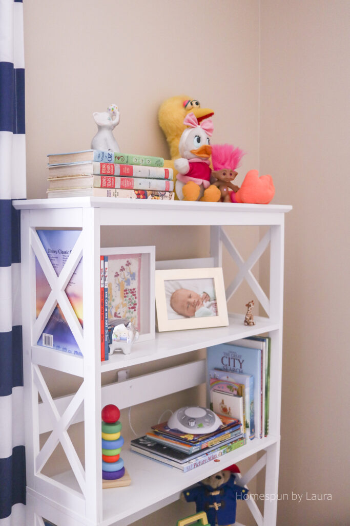 vintage toy nursery reveal - using mom and dad's childhood toys to decorate a nursery; pops of pink make it a pretty, cozy, and feminine space.