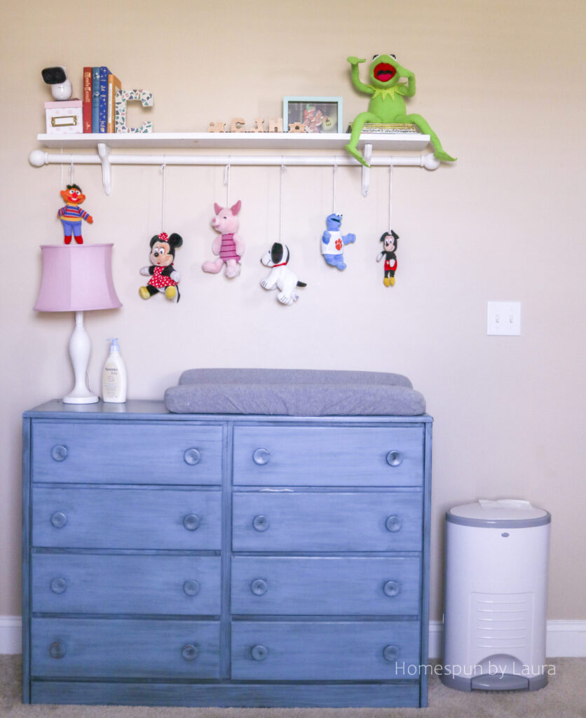 vintage toy nursery reveal - using mom and dad's childhood toys to decorate a nursery; pops of pink make it a pretty, cozy, and feminine space.